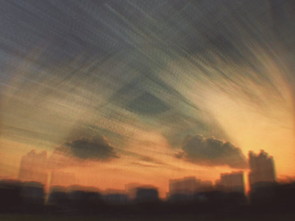 A dramatic abstract city sky at sunset with gentle GraceStone quote.